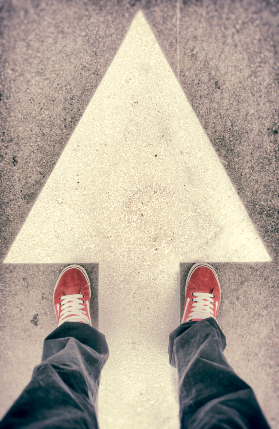 Shoes and forward arrow sign from above
