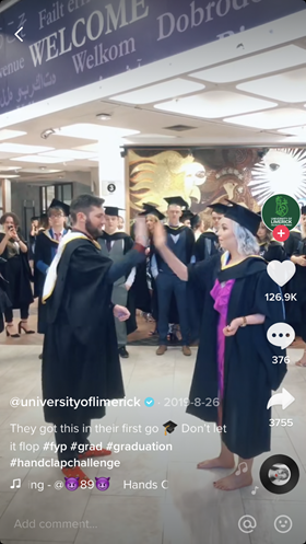 A screenshot of Tiktok showing happy graduating students for higher ed marketing.