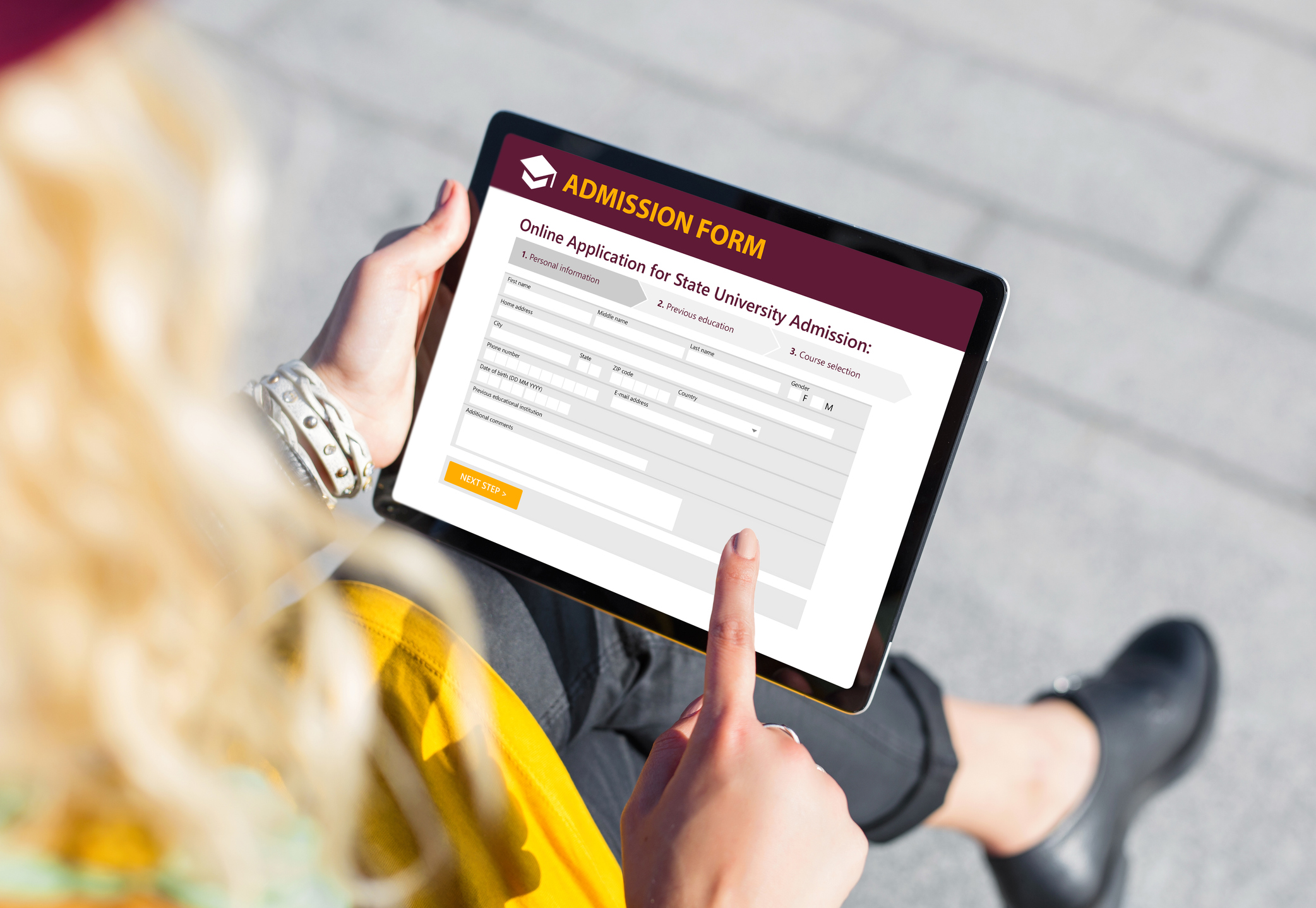 Student submitting online admission form on tablet computer